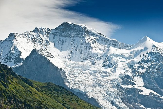 A glaciated summit and its hanging ice under a deep blue sky