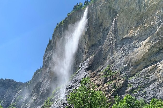 A long waterfall dropping down a sheer limestone cliff